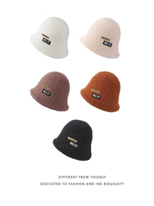 Detail showing five colors of plush bucket hats with retro patches on white background