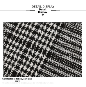 Detailed close-up showing the soft black and white houndstooth woven fabric of the peaked cap