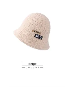 Close-up of beige fleece bucket hat with stylish patch detail and fluffy wool texture