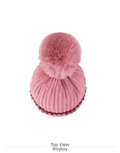 Top view of pink rib-knit hat showing the thick texture and large fluffy faux fur pompom