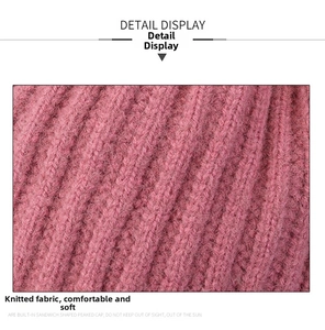 Detailed macro view of soft pink knitted fabric showing rib-knit texture and soft fibers