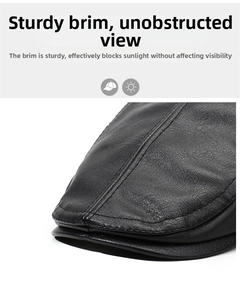 Detail of black leather flat cap brim showing premium lychee texture and sturdy stitching