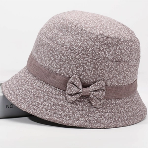 Detailed view of mauve floral fabric and side bow knot on elderly women's sun hat