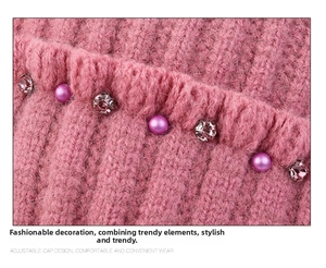 Close-up of pink knit hat featuring decorative pearls and sparkling rhinestones