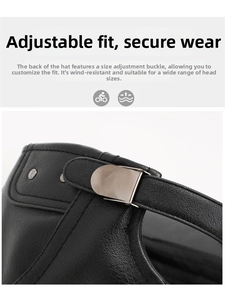 Detail of adjustable metal buckle and lychee textured black leather on the back of the cap