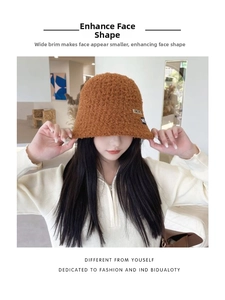 Close-up of brown faux shearling bucket hat with soft teddy texture and patch detail
