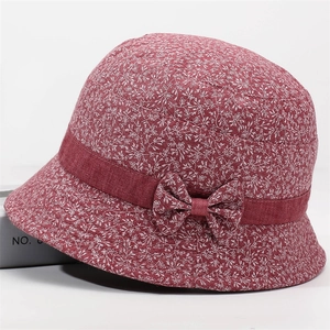 Detail of dark red floral bucket hat with cotton fabric and decorative side bow