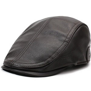 Detailed stitching on dark brown leather flat cap with classic paneled design