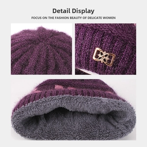 Detail showing purple knitted hat with thick fleece lining and golden bow ornament