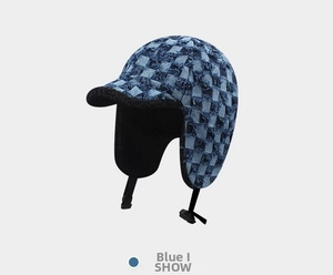 Detailed close-up of blue checkerboard trapper hat with warm black fleece lining