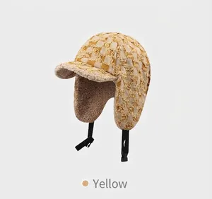 Detail of yellow plaid aviator hat with warm fleece lining and adjustable strap