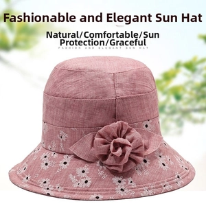 Detail of elegant pink cotton sun hat with floral pattern and 3D fabric flower decor