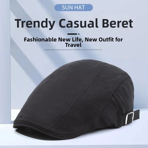 Close-up of black herringbone newsboy cap featuring an adjustable metal side buckle