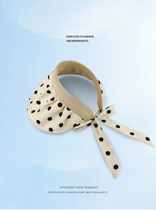 Polka dot sun visor with woven edge detail and elegant ribbon bow tie at the back