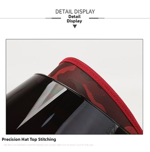 Détail de couture sur tissu camouflage rouge et visière en plastique translucide