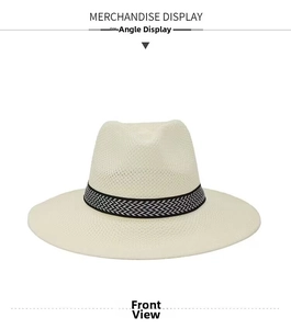 Front view of beige straw panama hat with black and white geometric pattern band