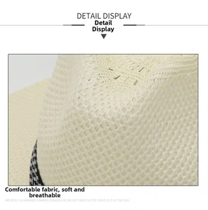 Detail view of breathable open-knit texture and houndstooth ribbon on summer beach hat