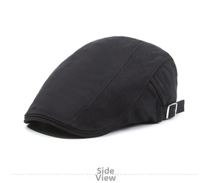 Side detail of black newsboy hat with herringbone texture and silver adjustment buckle