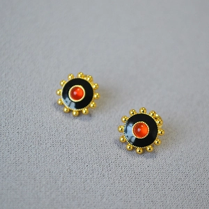 Vintage gear-shaped brass gold earrings with black enamel and red agate inlay