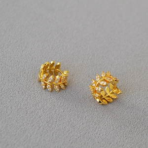 Golden olive leaf hoop earrings with shimmering cubic zirconia in a nature-inspired design