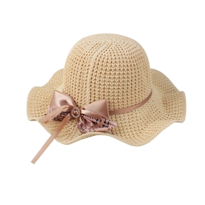 Women's breathable straw sun hat with pink bow and wavy brim for beach vacations