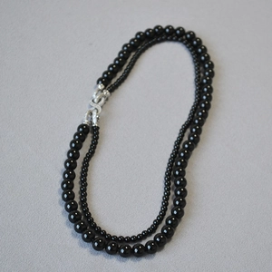 Collana a doppio strato di perle nere con chiusura a infinito in argento e stile lusso