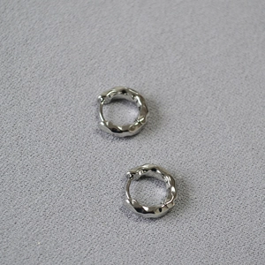Minimalist silver hoop earrings with irregular hammered lava texture and glossy finish