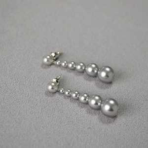Détail de boucles d'oreilles pendantes avec perles dégradées et tiges en argent