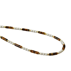 Tiger eye stone and pearl beaded necklace with gold spacers in vintage aesthetic