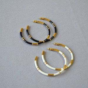 Oversize bamboo-style enamel hoop earrings in gold plated finish for fashion women