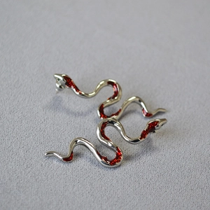 Silver snake drop earrings with red enamel details and S-shaped minimalist design