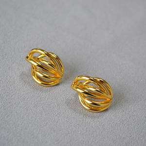 Detailed macro shot of gold hollow woven multilayered curved lines stud earrings