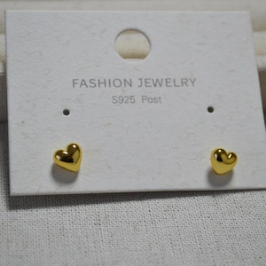 Detail of gold heart earrings on display card showing S925 sterling silver post