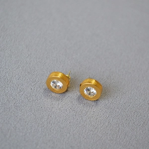 Minimalist gold disk stud earrings with brushed texture and sparkling center zircon