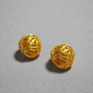 Detailed view of golden hollow woven spherical stud earrings with intricate 3D wire craft