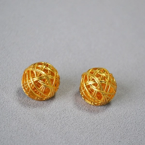 Elegant gold spherical stud earrings with a hollow woven textured metal design