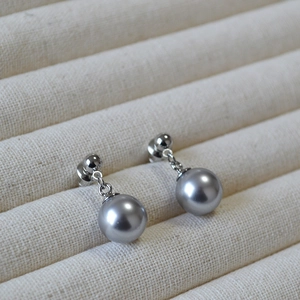 Elegant grey faux pearl stud earrings with 925 silver pins on a soft jewelry tray