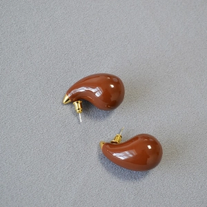 French retro dark brown enamel teardrop earrings with gold accents on grey fabric