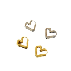 Minimalist gold and silver folded heart earrings with a modern wavy textured design