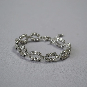 Chic faceted silver-toned bead woven chain bracelet with sparkling laser-cut finish