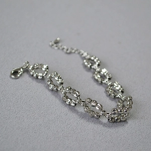 Macro view of silver faceted beads woven chain with lobster clasp and extension chain
