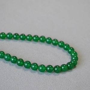 Short beaded necklace with translucent green agate and polished round jade beads