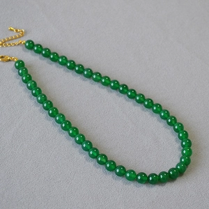 Detail of green agate beaded necklace with adjustable gold lobster clasp and extension chain