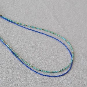 Detailed macro view of delicate turquoise and lapis lazuli beaded choker necklaces