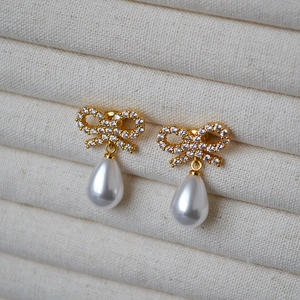 Elegant gold bow earrings with cubic zirconia and teardrop pearl drops for women