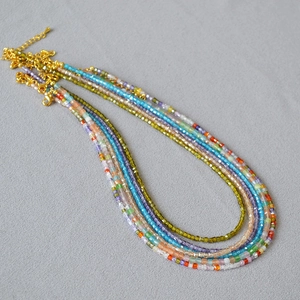 Detailed macro view of colorful square crystal beads and gold-plated lobster clasp