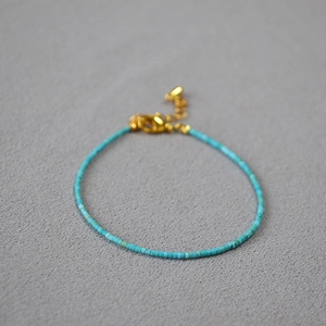 Minimalist turquoise beaded bracelet with gold lobster clasp and adjustable chain