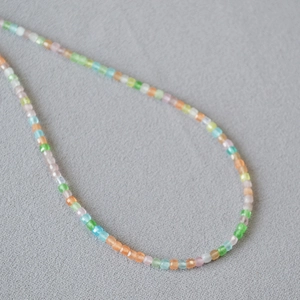 Detail of colorful faceted crystal beads in mint, blue, and peach for dainty necklaces