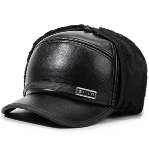 Detail of black faux leather aviator hat with warm plush lining and metal logo plate