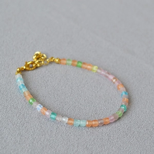 Detailed shot of multi-color faceted bead bracelet with golden adjustable lobster clasp